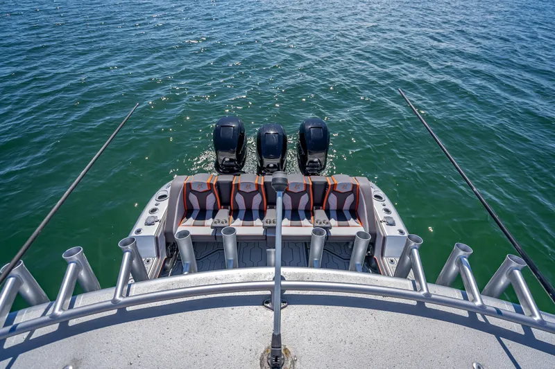 Slide: The Image of 2012 Yellowfin 39 boat with triple outboard engines on open water. - 27