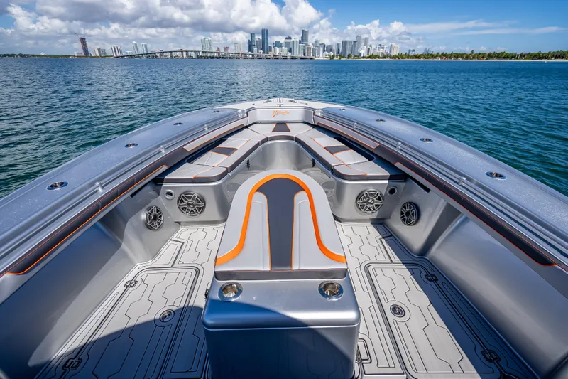 Slide: The Image of 2012 Yellowfin 39 boat interior with city skyline in background, featuring sleek seating and speakers. - 28
