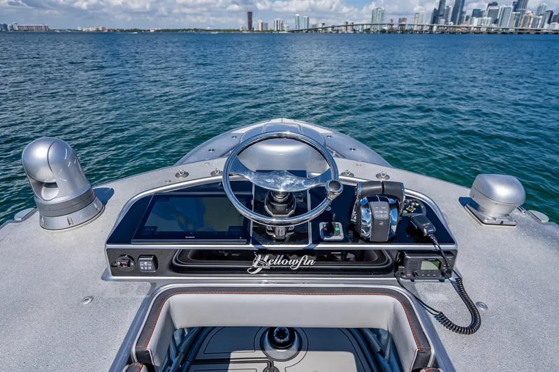 Slide: The Image of 2012 Yellowfin 39 boat helm with city skyline in the background. - 31