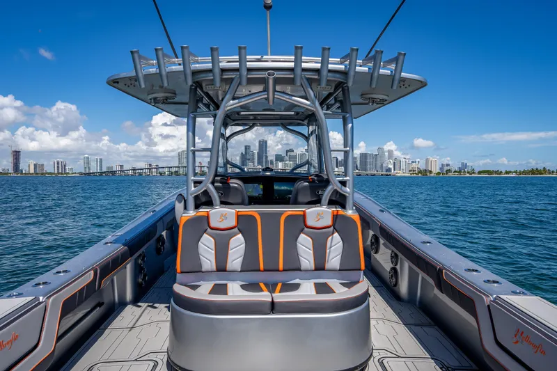 Slide: The Image of 2012 Yellowfin 39 boat on water with city skyline in background. - 32