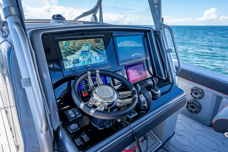 Slide: The Image of Steering console of a 2012 Yellowfin 39 boat with advanced navigation displays. - 35