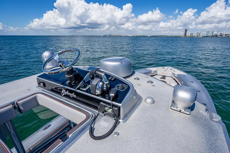 Slide: The Image of 2012 Yellowfin 39 boat dashboard with ocean view and city skyline in the background. - 37