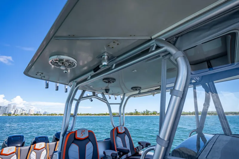 Slide: The Image of 2012 Yellowfin 39 boat interior with seating, ocean view, and city skyline in background. - 43