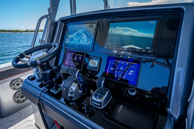 Slide: The Image of 2012 Yellowfin 39 boat dashboard with advanced navigation and control systems. - 44