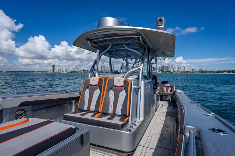 Slide: The Image of 2012 Yellowfin 39 boat with sleek seating, cruising on a sunny day near city skyline. - 50