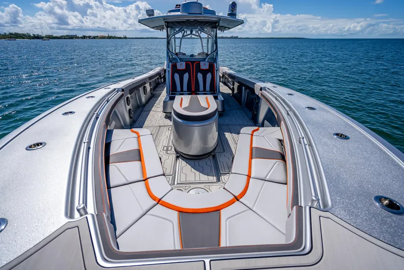 Slide: The Image of 2012 Yellowfin 39 boat with sleek seating, cruising on open water under a clear sky. - 52