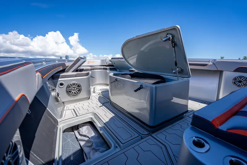 Slide: The Image of 2012 Yellowfin 39 boat interior with open storage, sleek design, and blue sky background. - 59