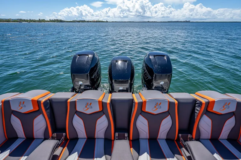 Slide: The Image of 2012 Yellowfin 39 boat with triple outboard engines and stylish seating on open water. - 6