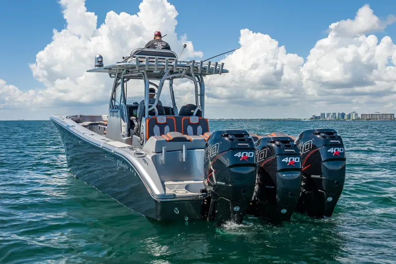 Slide: The Image of 2012 Yellowfin 39 boat with triple 400R outboard engines on open water. - 60