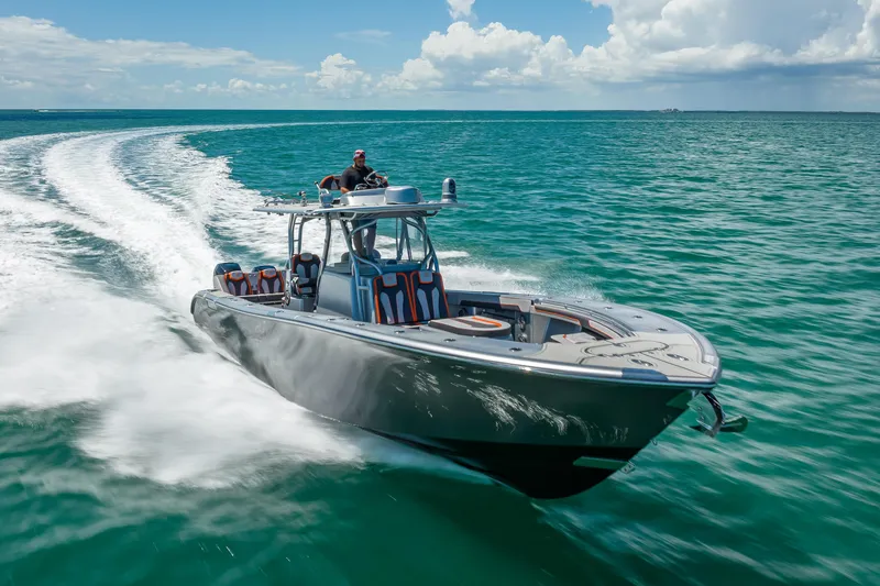 Slide: The Image of 2012 Yellowfin 39 boat cruising on open water, creating a dynamic wake. - 64