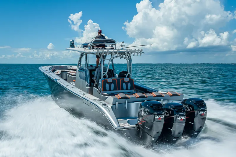 Slide: The Image of 2012 Yellowfin 39 boat cruising on open water with four powerful engines. - 73