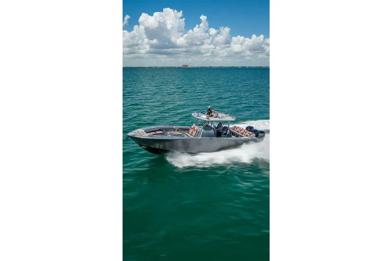 Slide: The Image of 2012 Yellowfin 39 boat cruising on open water under a partly cloudy sky. - 76