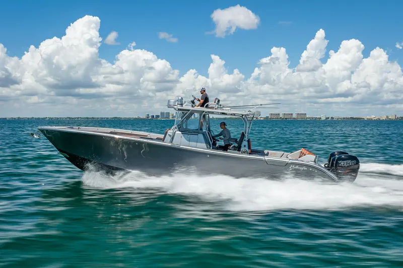 Slide: The Image of 2012 Yellowfin 39 boat cruising on open water under a clear blue sky. - 79