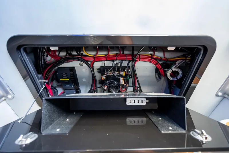 Slide: The Image of Electrical wiring compartment of a 2012 Yellowfin 39 boat, showcasing organized cables and components. - 8