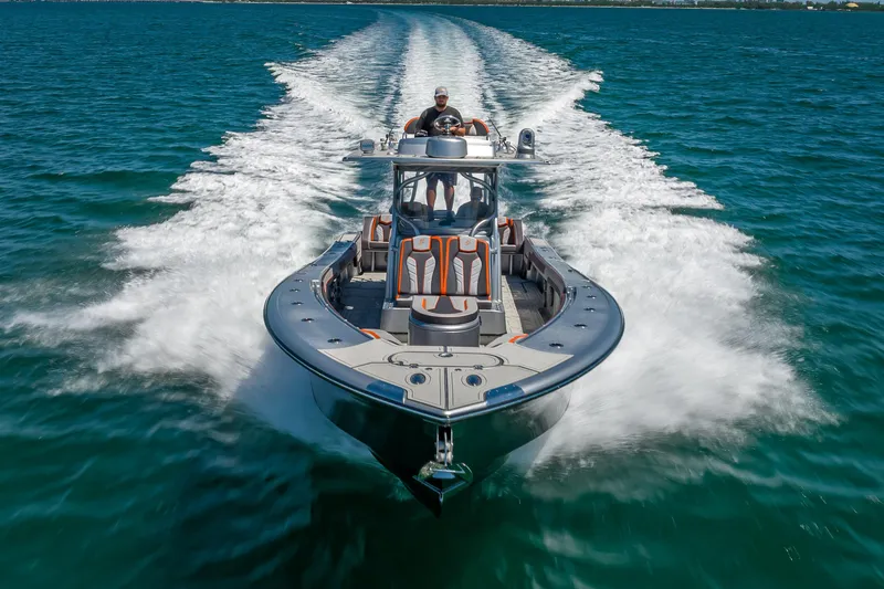 Slide: The Image of 2012 Yellowfin 39 boat cruising on open water, leaving a wake trail. - 80