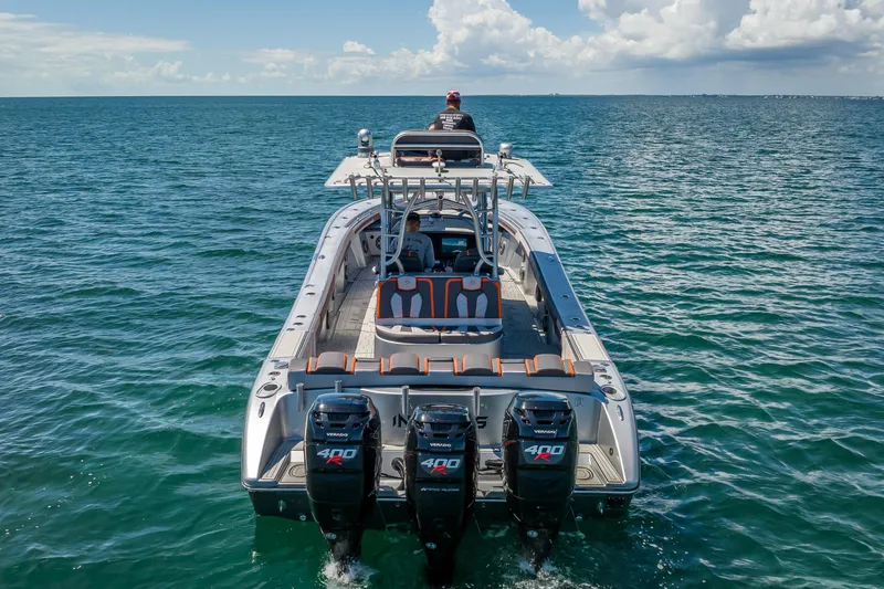 Slide: The Image of 2012 Yellowfin 39 boat with triple outboard engines on open water. - 81