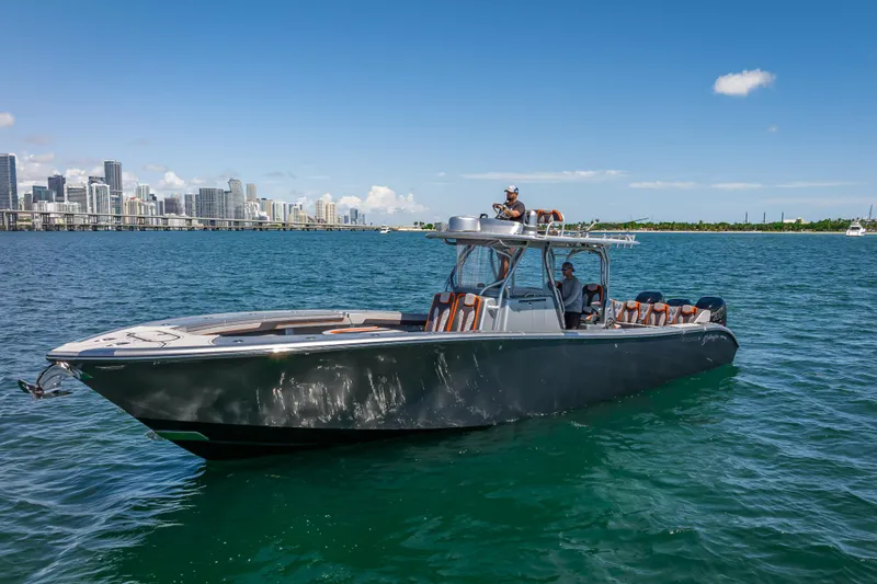Slide: The Image of 2012 Yellowfin 39 boat cruising near city skyline on a sunny day. - 83