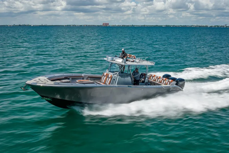 Slide: The Image of 2012 Yellowfin 39 boat cruising on open water under a cloudy sky. - 85