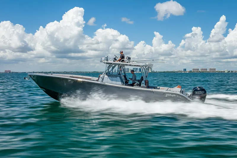 Slide: The Image of 2012 Yellowfin 39 boat cruising on open water under a cloudy sky. - 88