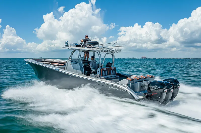 Slide: The Image of 2012 Yellowfin 39 boat speeding on ocean under clear blue sky. - 89