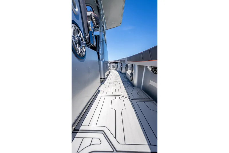 Slide: The Image of 2012 Yellowfin 39 boat deck with modern design and speakers, under clear blue sky. - 9