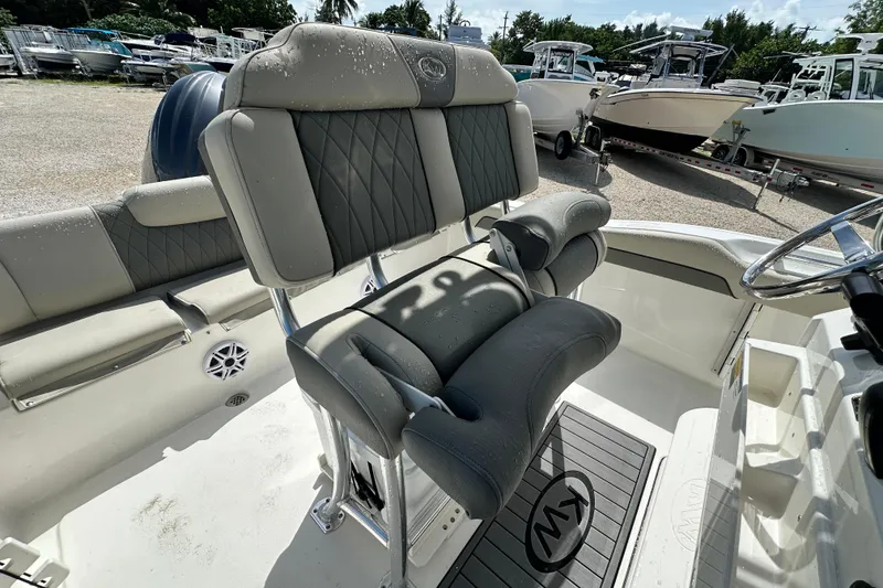 Slide: The Image of 2026 Key West 219 FS boat interior with cushioned seating and steering wheel. - 10