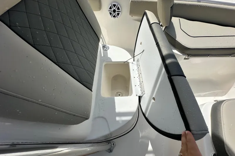 Slide: The Image of 2026 Key West 219 FS boat seat storage compartment with quilted upholstery and water droplets. - 12