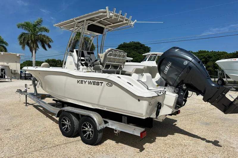Slide: The Image of 2026 Key West 219 FS boat on trailer with Yamaha outboard motor, parked outdoors. - 3