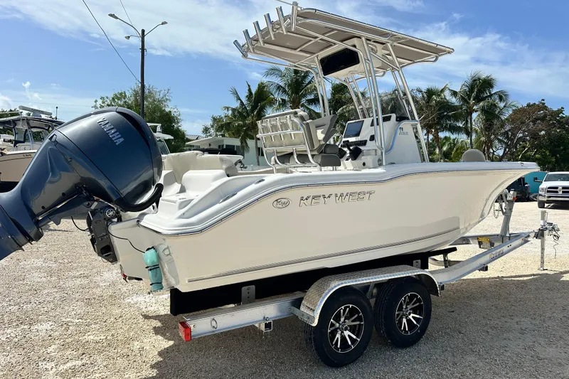Slide: The Image of 2026 Key West 219 FS boat on trailer with Yamaha engine, parked outdoors. - 5