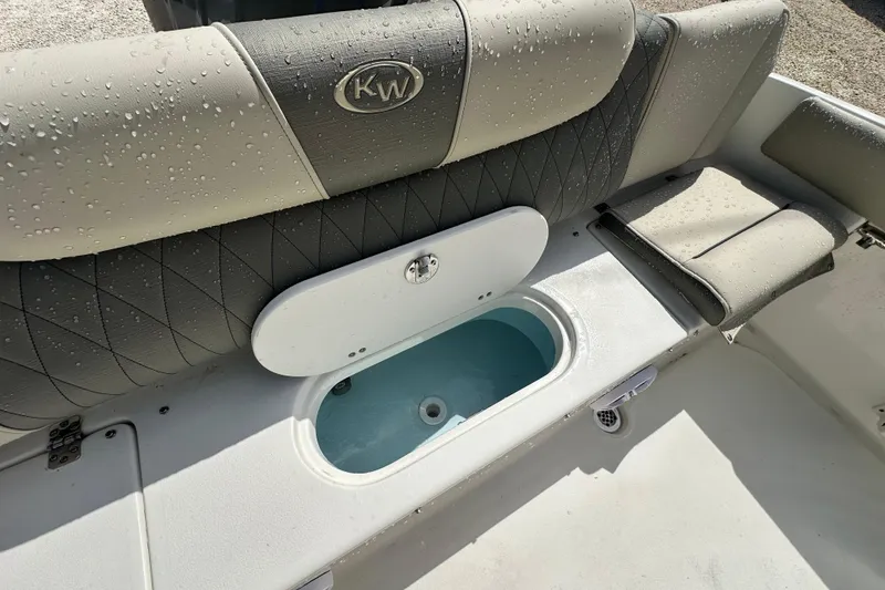 Slide: The Image of 2026 Key West 219 FS boat interior with wet seating and storage compartment. - 7