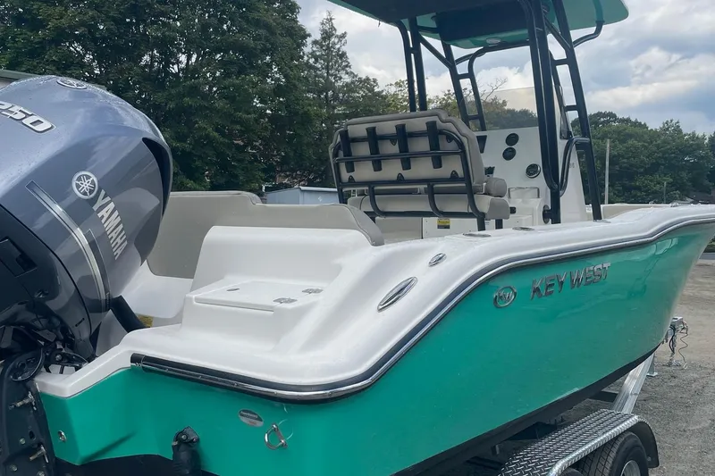 Slide: The Image of 2024 Key West 239 FS boat with Yamaha engine, teal hull, and dual seating. - 1