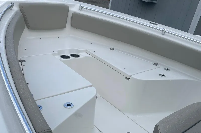 Slide: The Image of 2024 Key West 239 FS boat interior with cushioned seating and cup holders. - 10