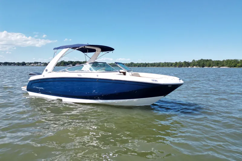 Slide: The Image of 2019 Regal 26 OBX boat on calm water under clear blue sky. - 1