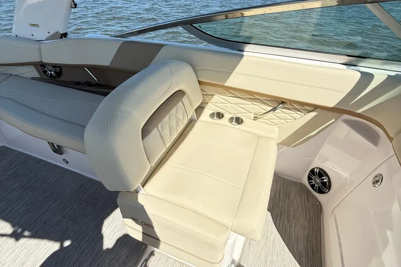 Slide: The Image of 2019 Regal 26 OBX boat interior with beige seating and cup holders. - 13