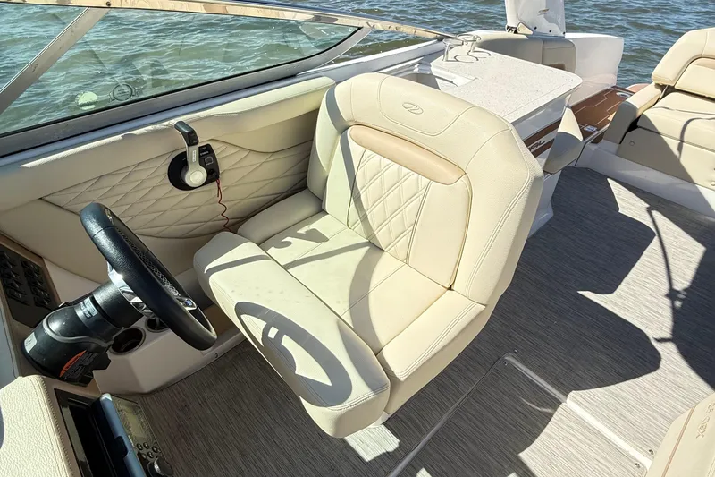 Slide: The Image of 2019 Regal 26 OBX boat interior with beige seating and steering wheel. - 14