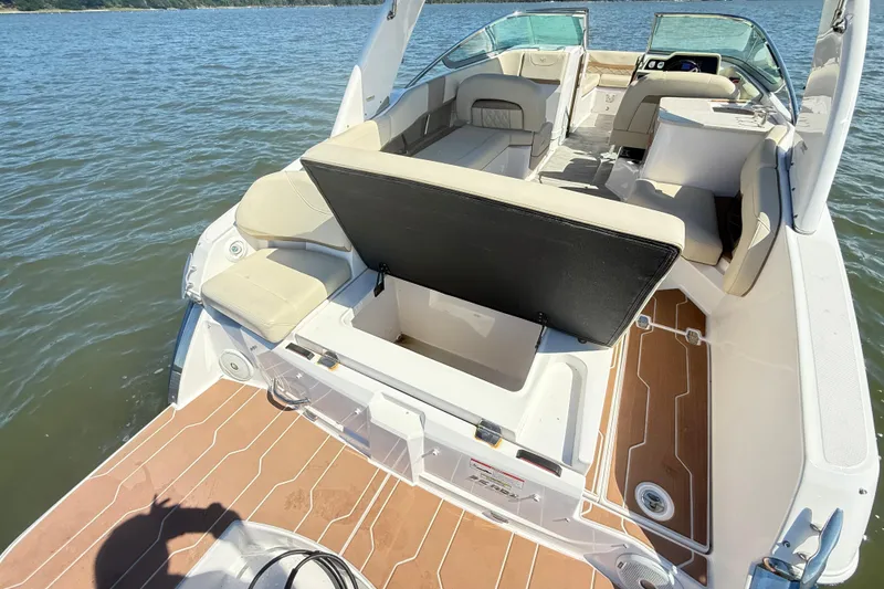 Slide: The Image of 2019 Regal 26 OBX boat interior with open storage compartment on the water. - 16