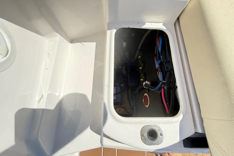 Slide: The Image of Storage compartment with wiring inside a 2019 Regal 26 OBX boat. - 20
