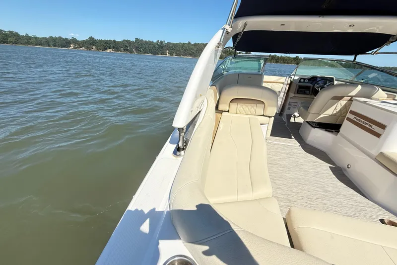 Slide: The Image of 2019 Regal 26 OBX boat interior with beige seating on a sunny day. - 23