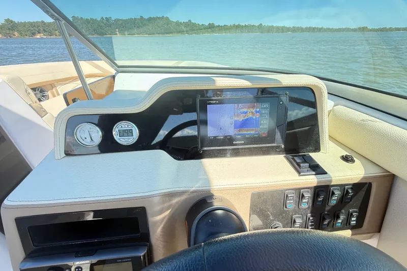 Slide: The Image of 2019 Regal 26 OBX boat dashboard with Garmin navigation system on a sunny day. - 24