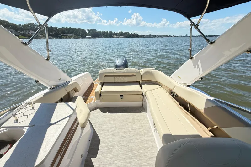 Slide: The Image of 2019 Regal 26 OBX boat interior with spacious seating on a sunny lake. - 4