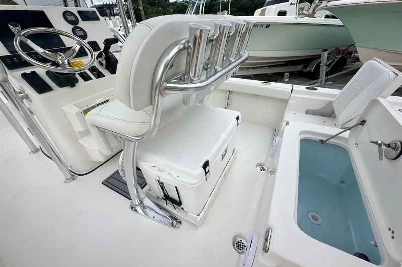Slide: The Image of 2026 Key West 210 Bay Reef boat interior with steering console and seating. - 10