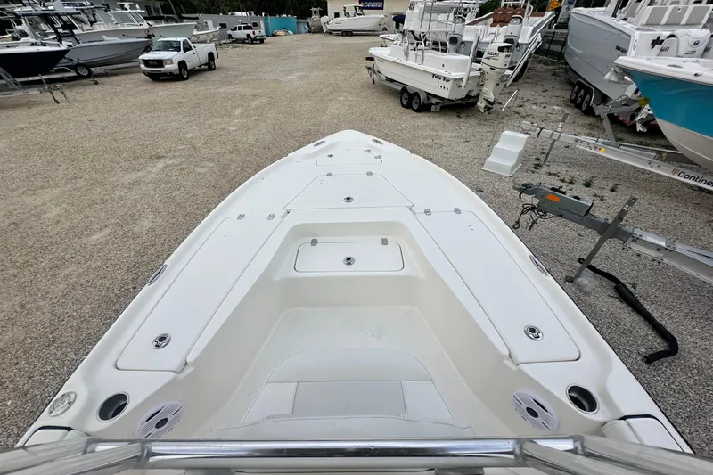 Slide: The Image of 2026 Key West 210 Bay Reef boat in a marina, surrounded by other boats and vehicles. - 11