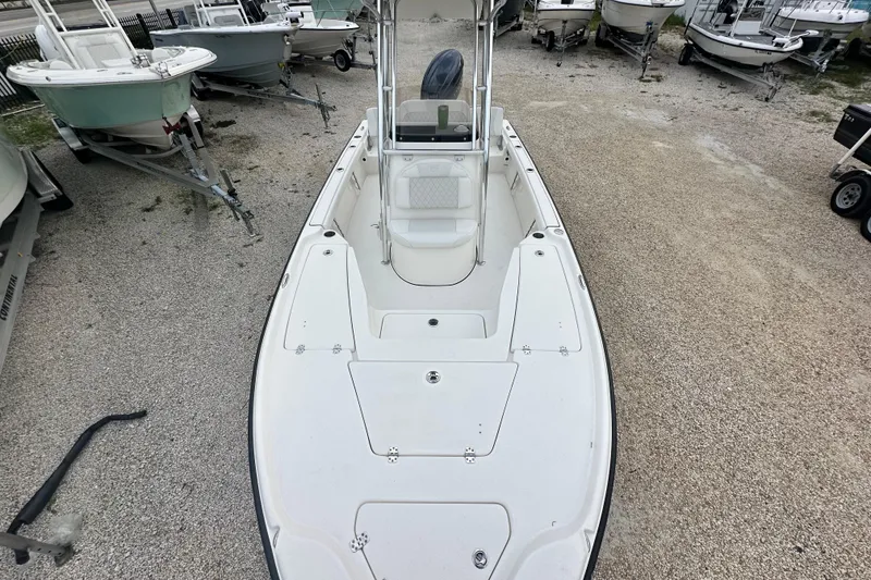 Slide: The Image of 2026 Key West 210 Bay Reef boat on gravel lot, surrounded by other boats. - 17
