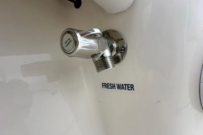 Slide: The Image of 2026 Key West 210 Bay Reef fresh water outlet, chrome finish, close-up view. - 19