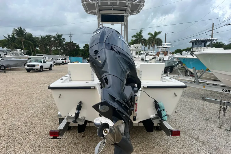 Slide: The Image of 2026 Key West 210 Bay Reef boat with Yamaha outboard motor, parked on gravel lot. - 4