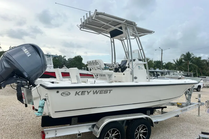 Slide: The Image of 2026 Key West 210 Bay Reef boat on trailer with Yamaha engine, parked outdoors. - 5