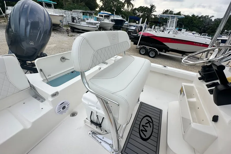 Slide: The Image of 2026 Key West 210 Bay Reef boat interior with white seating and steering wheel. - 8