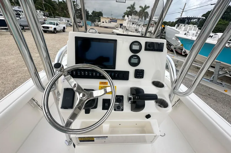 Slide: The Image of 2026 Key West 210 Bay Reef boat console with steering wheel and navigation controls. - 9