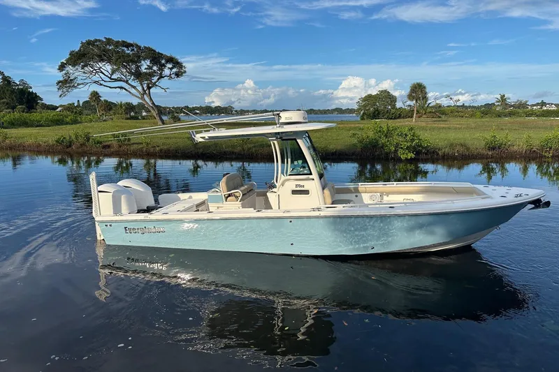 Slide: The Image of 2019 Everglades 273 Center Console boat on calm water, scenic background. - 1