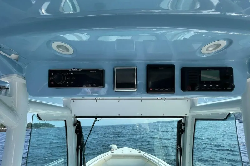 Slide: The Image of 2019 Everglades 273 Center Console dashboard with navigation and audio systems. - 13